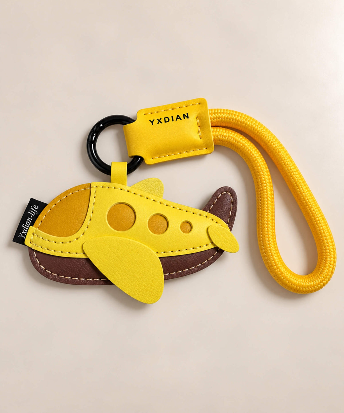 Yellow and brown airplane PU leather bag charm keychain with stitched wings and wrist loop