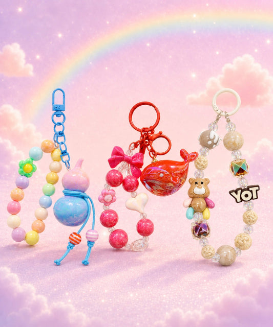 Cute beaded keychains with colourful bear, whale and gourd bag charms on a pastel rainbow background