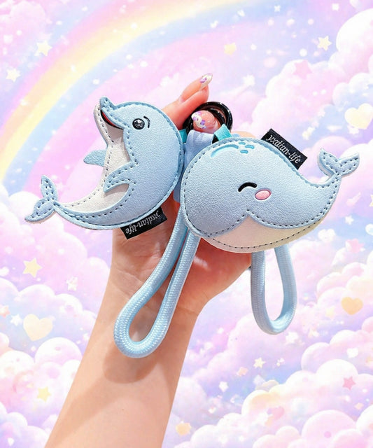 CHARMAZING Cute Ocean Animal PU leather keychains with dolphin and whale designs, held against a pastel rainbow background.