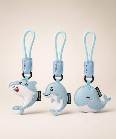 Cute ocean animal PU leather keychains featuring shark, dolphin and whale designs on a clean neutral background.