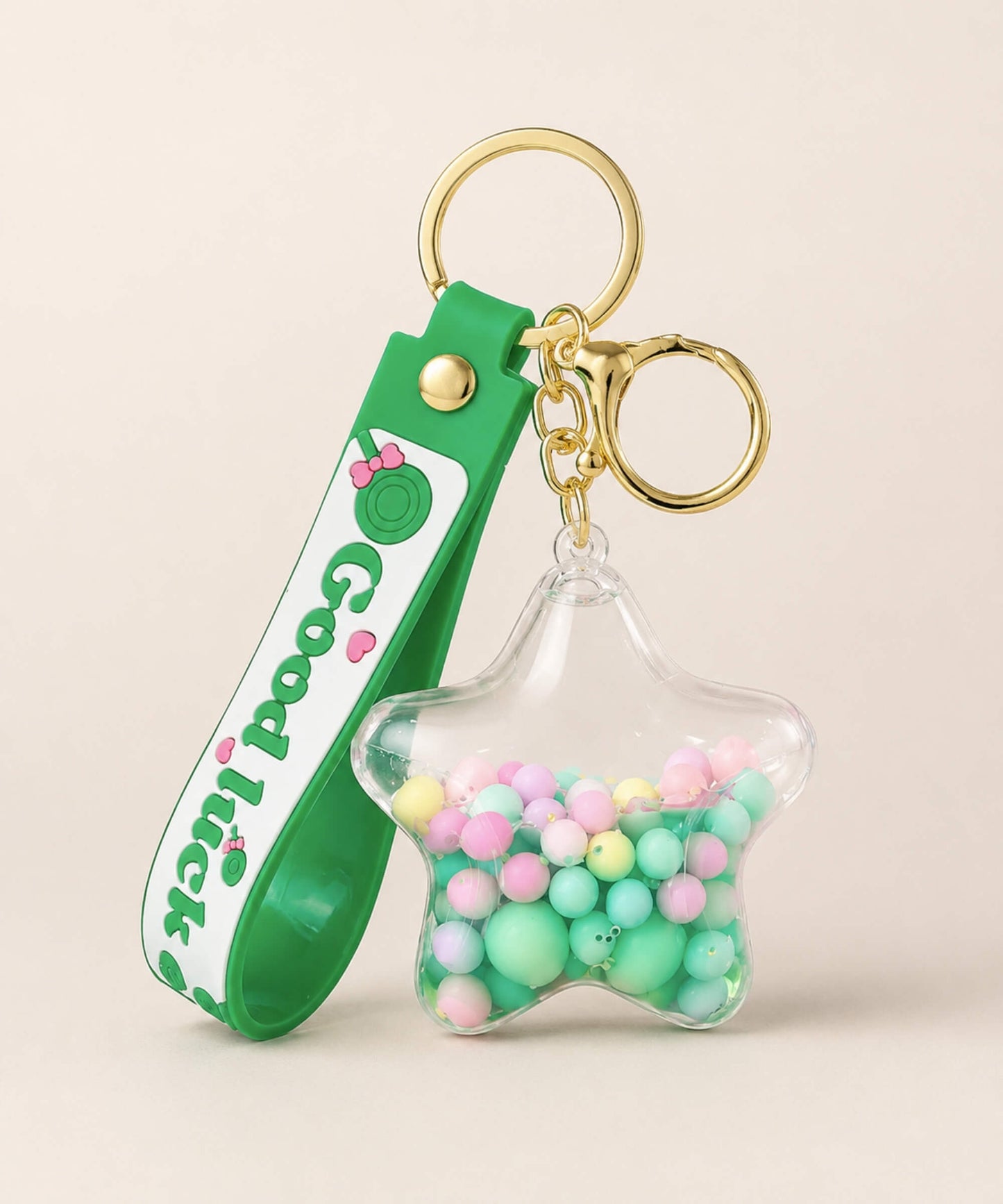 Good Luck star liquid keychain with pastel beads, green strap and gold hardware
