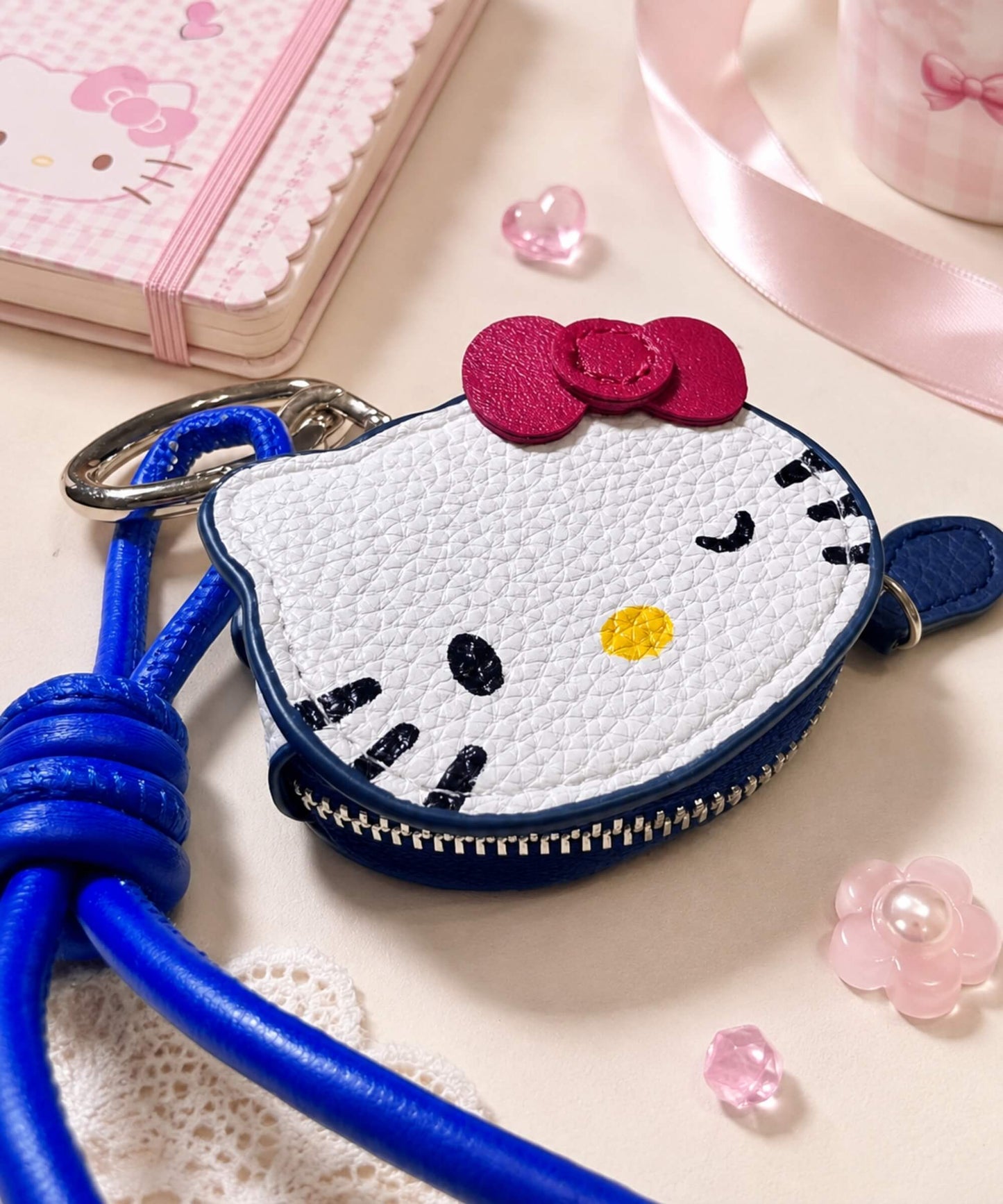 Hello Kitty coin purse keychain styled with pastel stationery, bow detail and PU leather-style texture