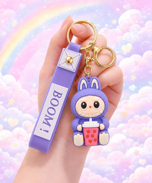 Purple Labubu style bubble tea keychain held in hand