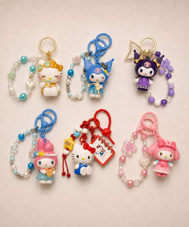 Sanrio beaded keychains featuring Hello Kitty, My Melody and Kuromi with tea, violin, accordion, princess and book designs