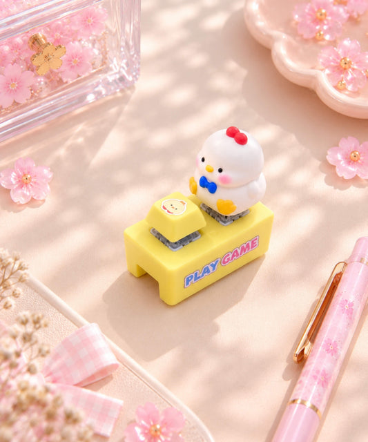 White chick sound and light button keychain styled on a pink desk
