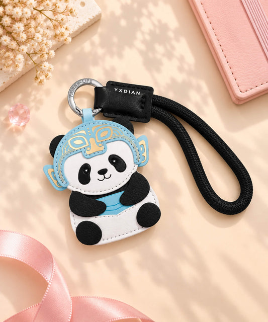 Panda Chinese opera-inspired PU leather bag charm keychain styled on a soft pink background