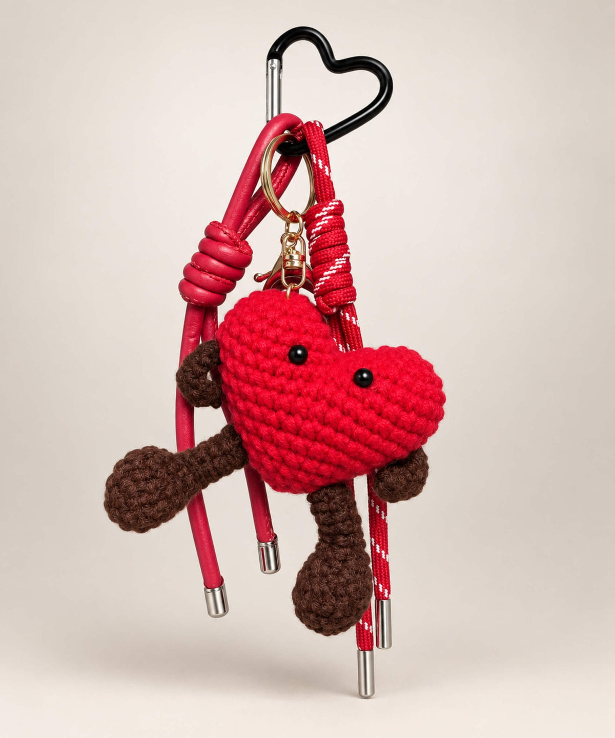 Red heart character crochet keychain with brown arms legs and matching hanging cords