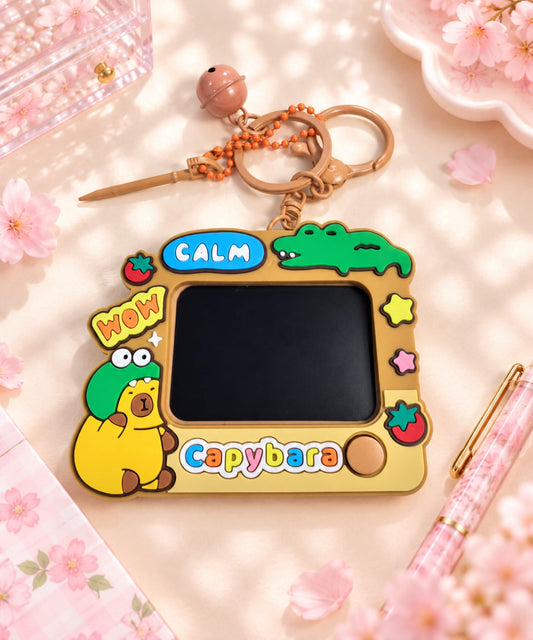 Capybara LCD Drawing & Writing Tablet Keychain styled on a desk