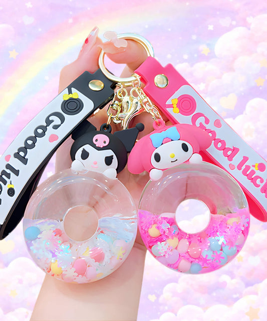 Sanrio donut liquid keychains with Kuromi and My Melody designs held in hand, cute shaker charm with floating beads and pastel background
