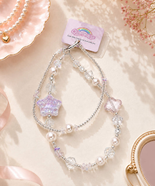 Purple Starry beaded phone charm with pearl-look and crystal-style beads in a soft pastel lifestyle setting