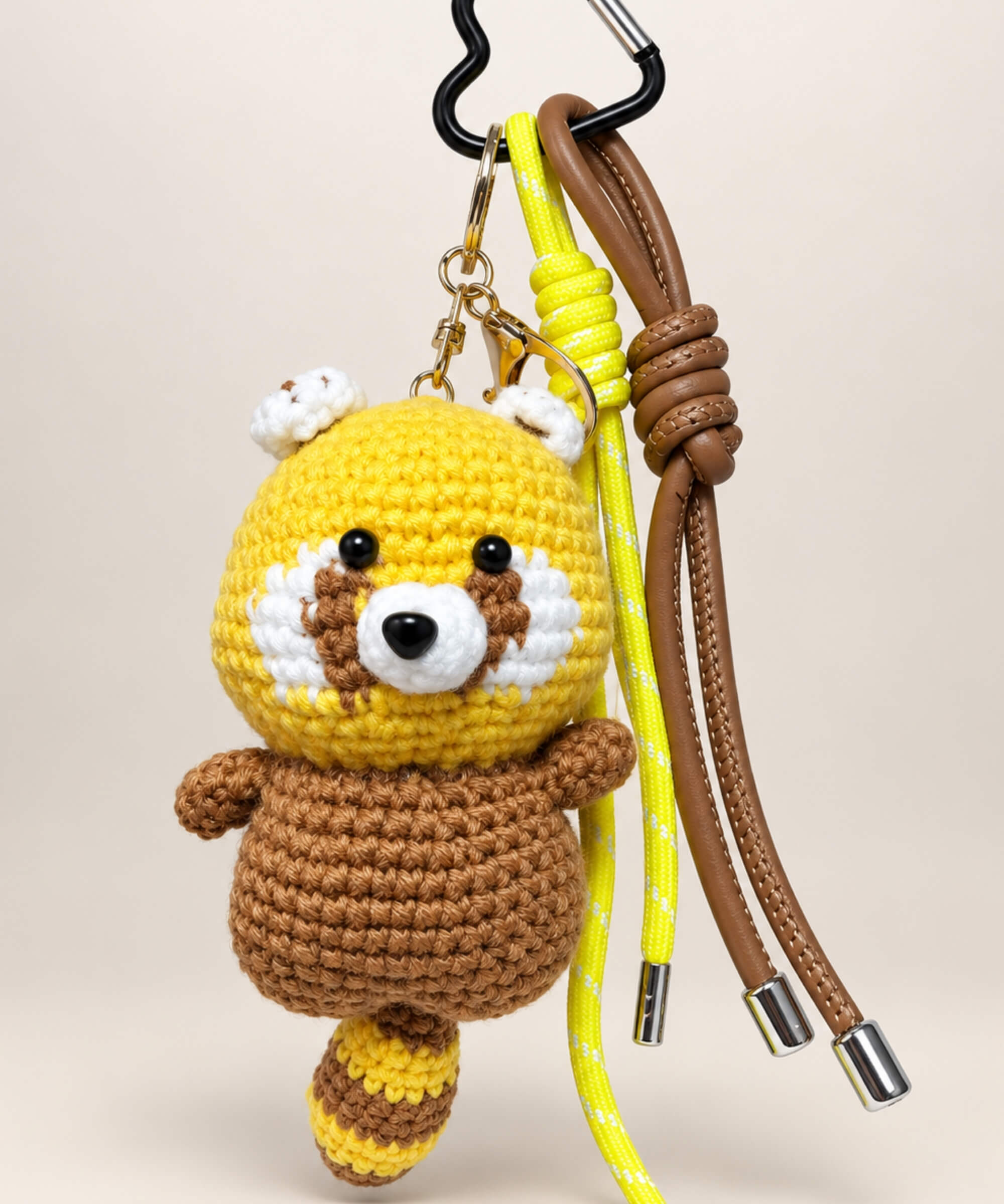 Yellow red panda crochet keychain with brown body and hanging cords