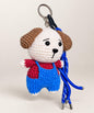 Puppy crochet keychain wearing blue overalls with blue hanging cords