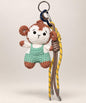 Monkey crochet keychain wearing mint overalls with brown and yellow hanging cords