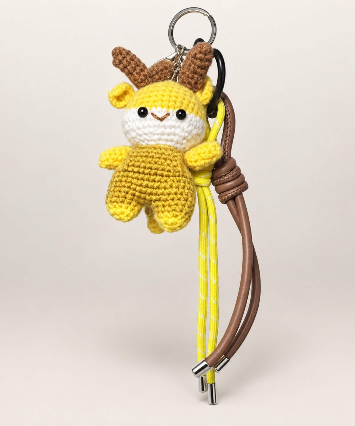 Yellow deer crochet keychain with brown antlers and hanging cords