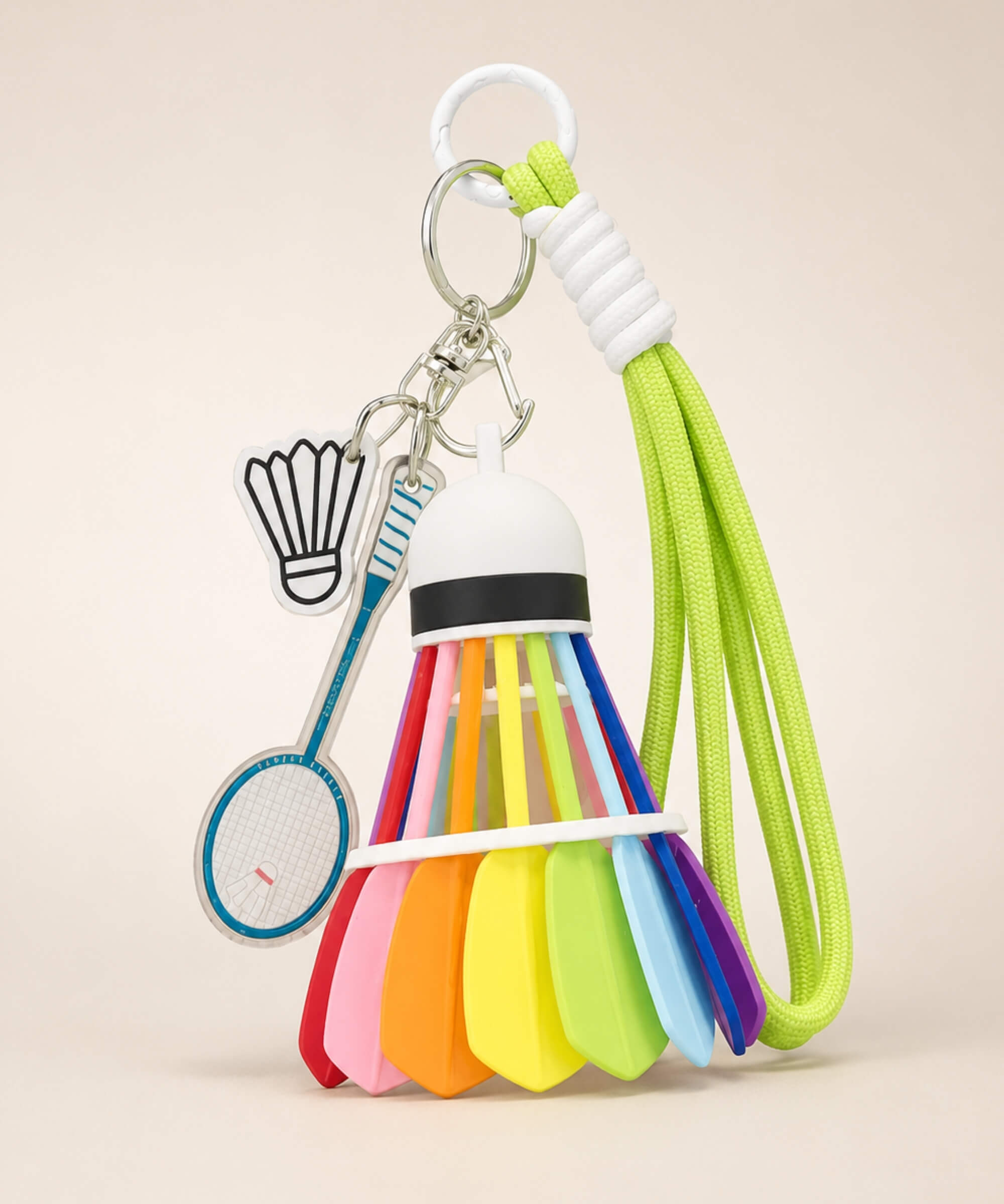 Lime green badminton shuttlecock rope keychain with blue racket charm and shuttlecock charm on neutral background