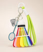Lime green badminton shuttlecock rope keychain with blue racket charm and shuttlecock charm on neutral background