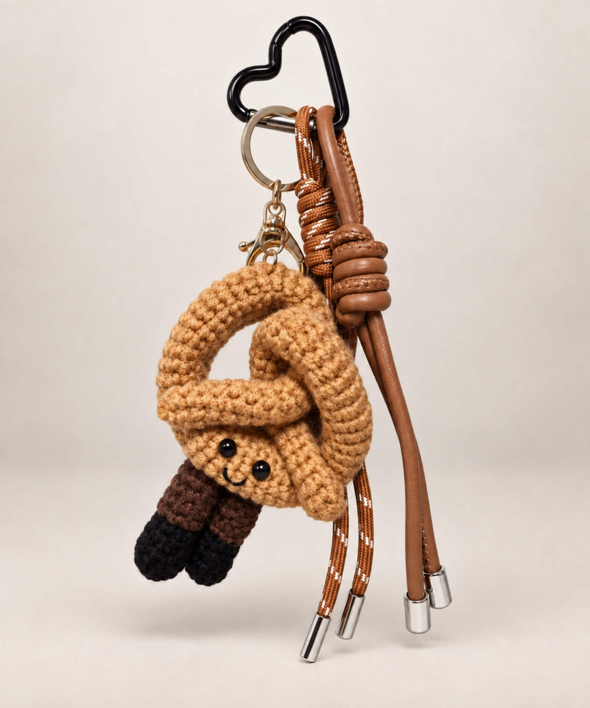 Brown pretzel bakery crochet keychain with cute smiling face and coordinating straps