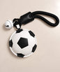 Football PU leather-look bag charm keychain styled on a warm neutral background