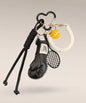 Black boxing glove and tennis rope keychain with white coiled strap and tennis ball charm