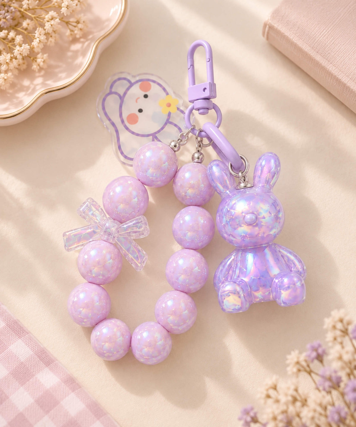 Purple bunny beaded keychain with iridescent beads, clear bow detail, rabbit charm and purple clip