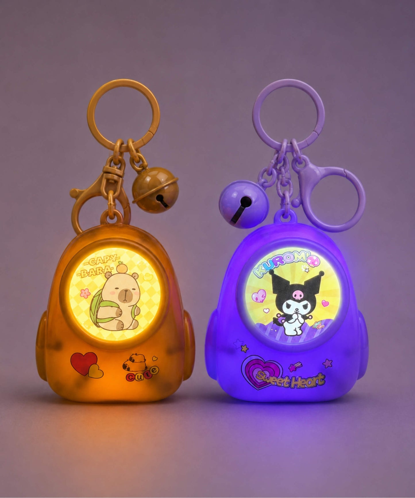 Capybara and Kuromi light-up backpack keychains glowing in the dark
