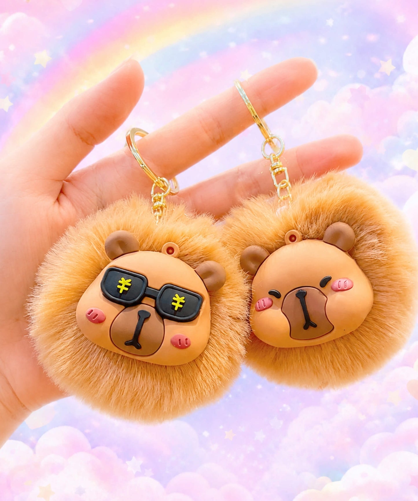 Two capybara plush keychains with rainbow background