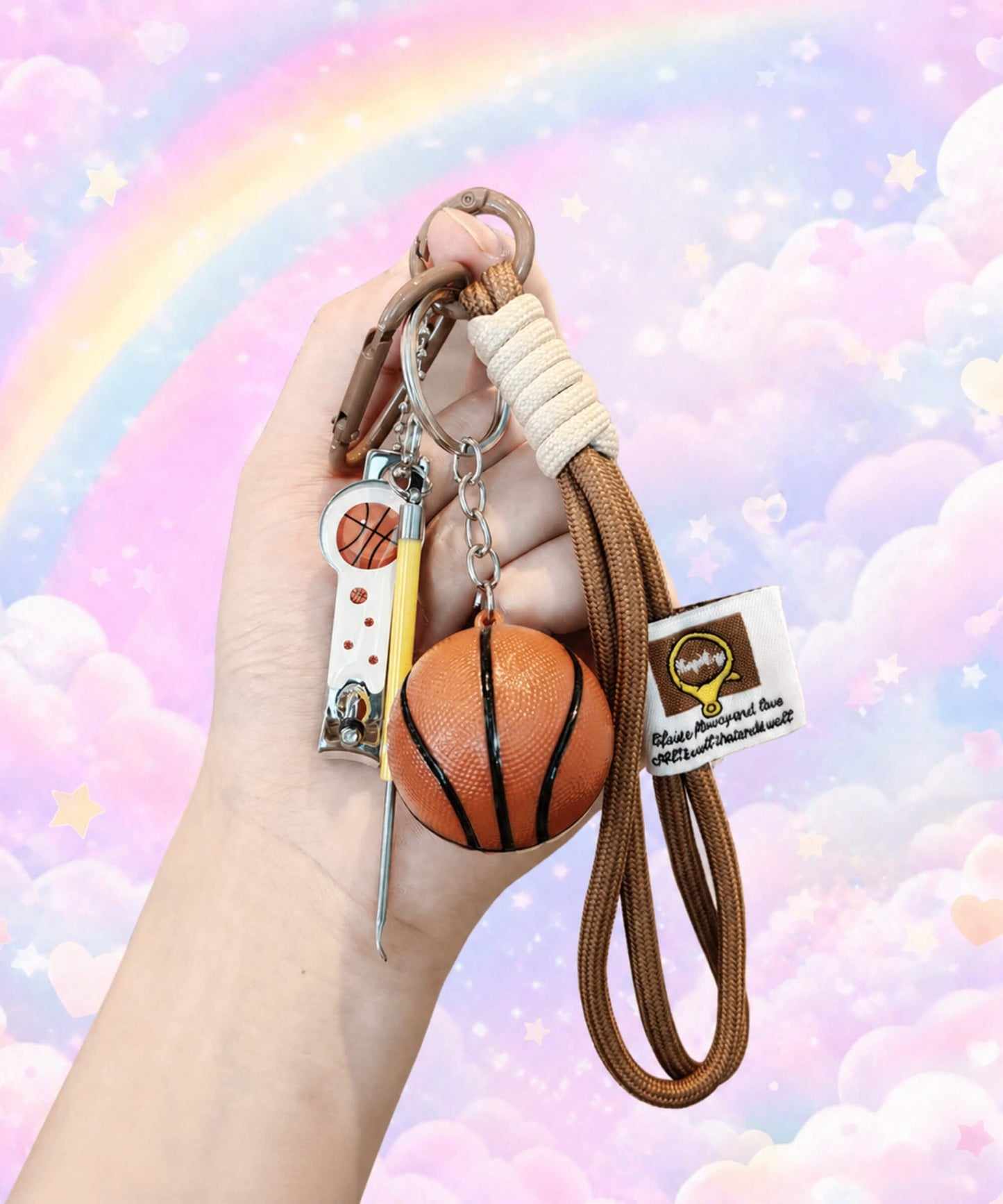 Basketball rope keychain held by hand with basketball charm, mini tool and pastel rainbow background