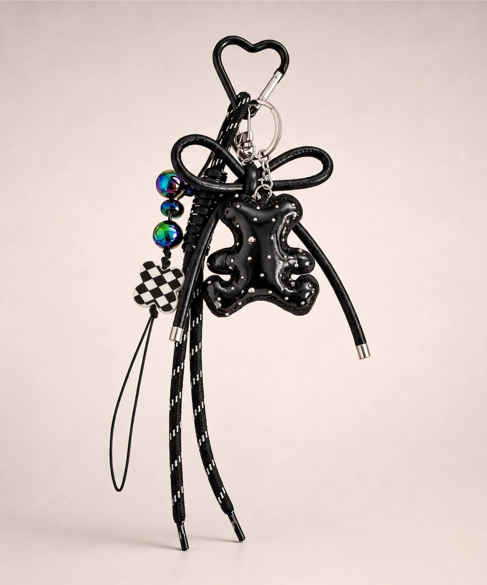 Black bear PU leather bag charm keychain with a sparkle charm and decorative hanging charms on a neutral background.