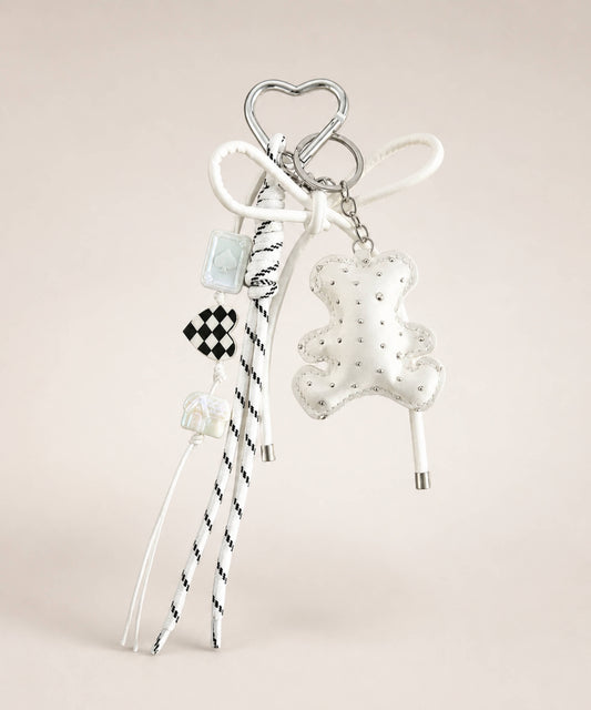 White bear PU leather bag charm keychain with a sparkle charm and decorative hanging charms on a neutral background.
