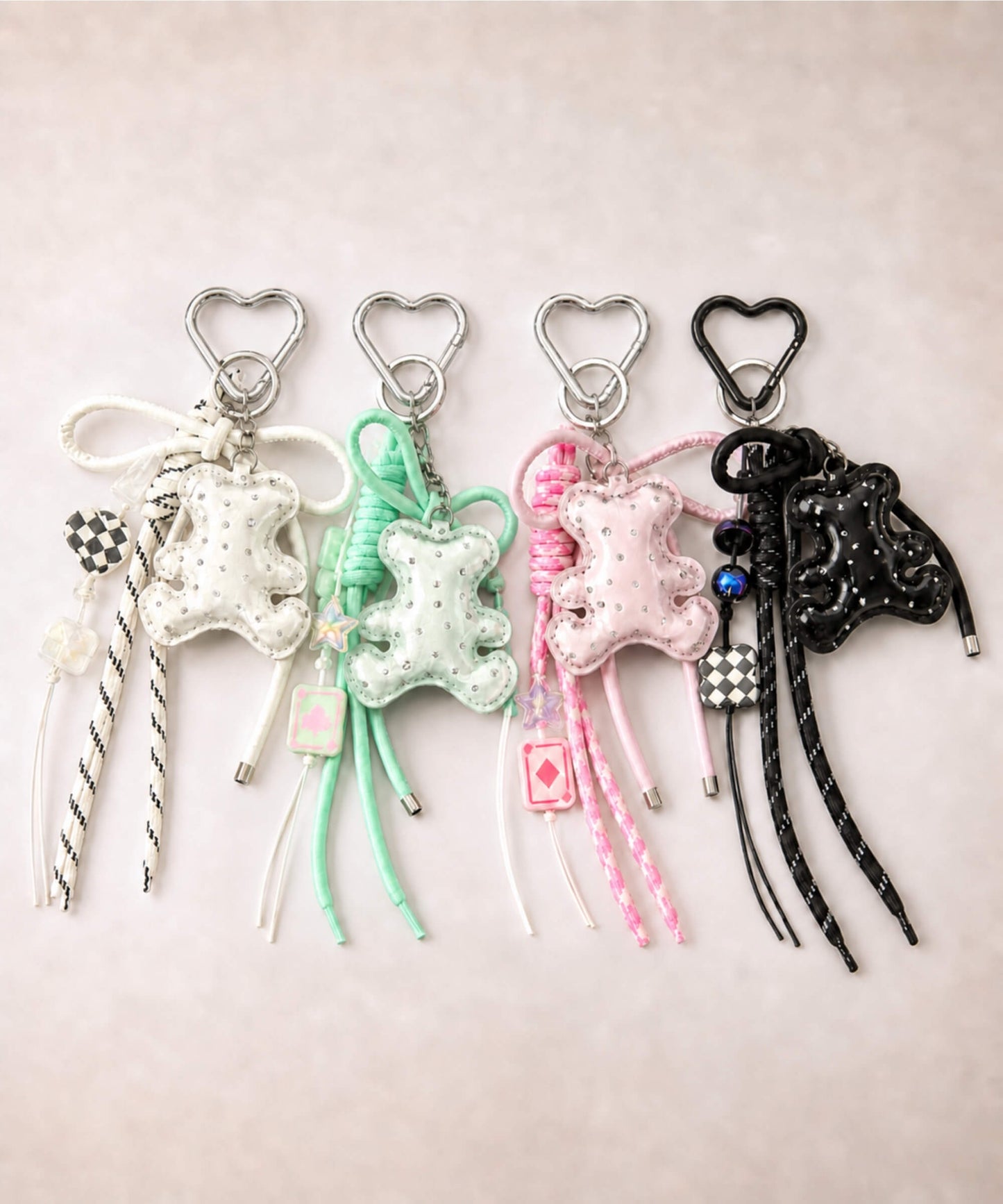 White, green, pink and black bear PU leather bag charm keychains with sparkle charms displayed together on a neutral background.