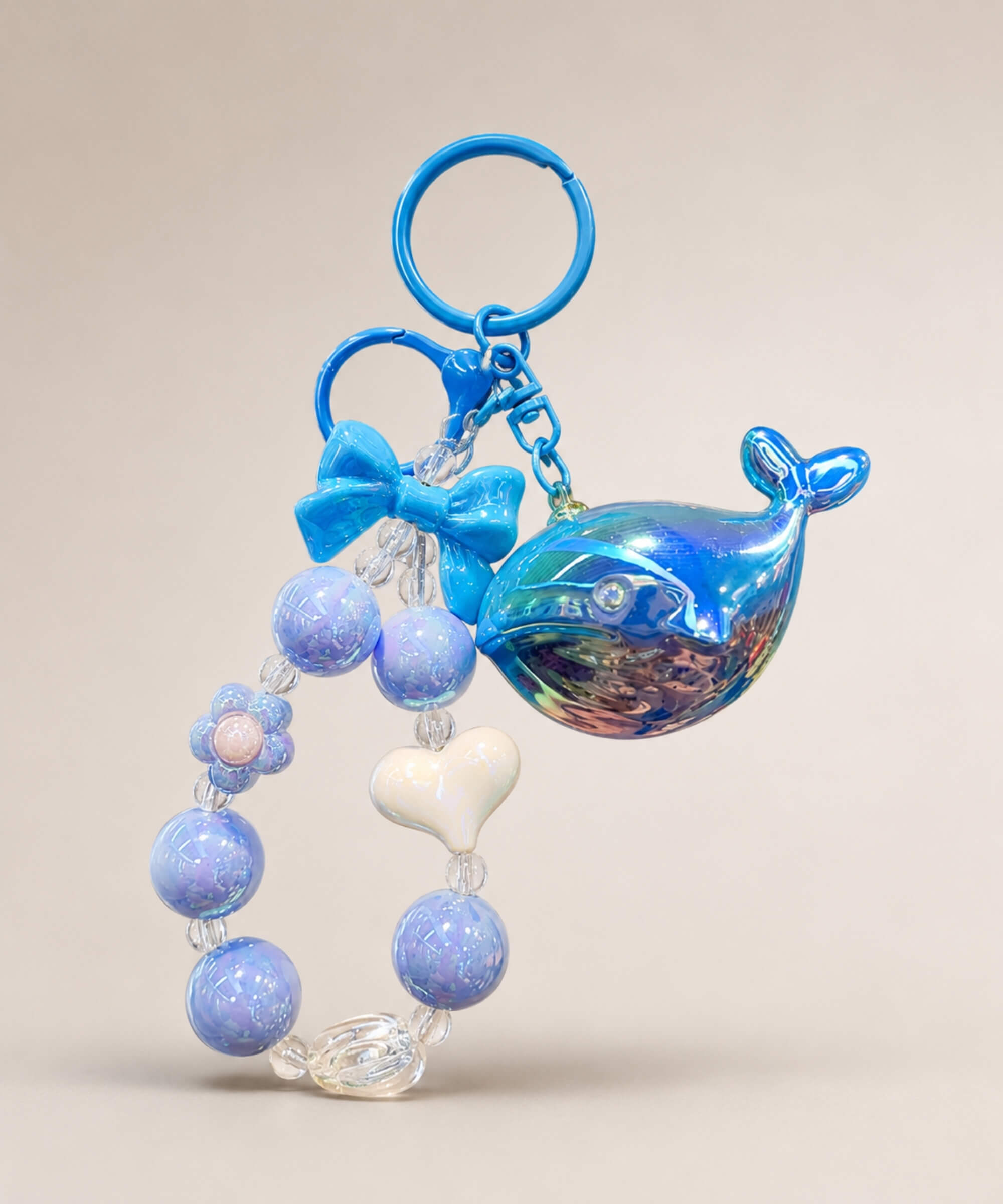 Blue whale beaded keychain with glossy blue beads, bow charm and heart detail