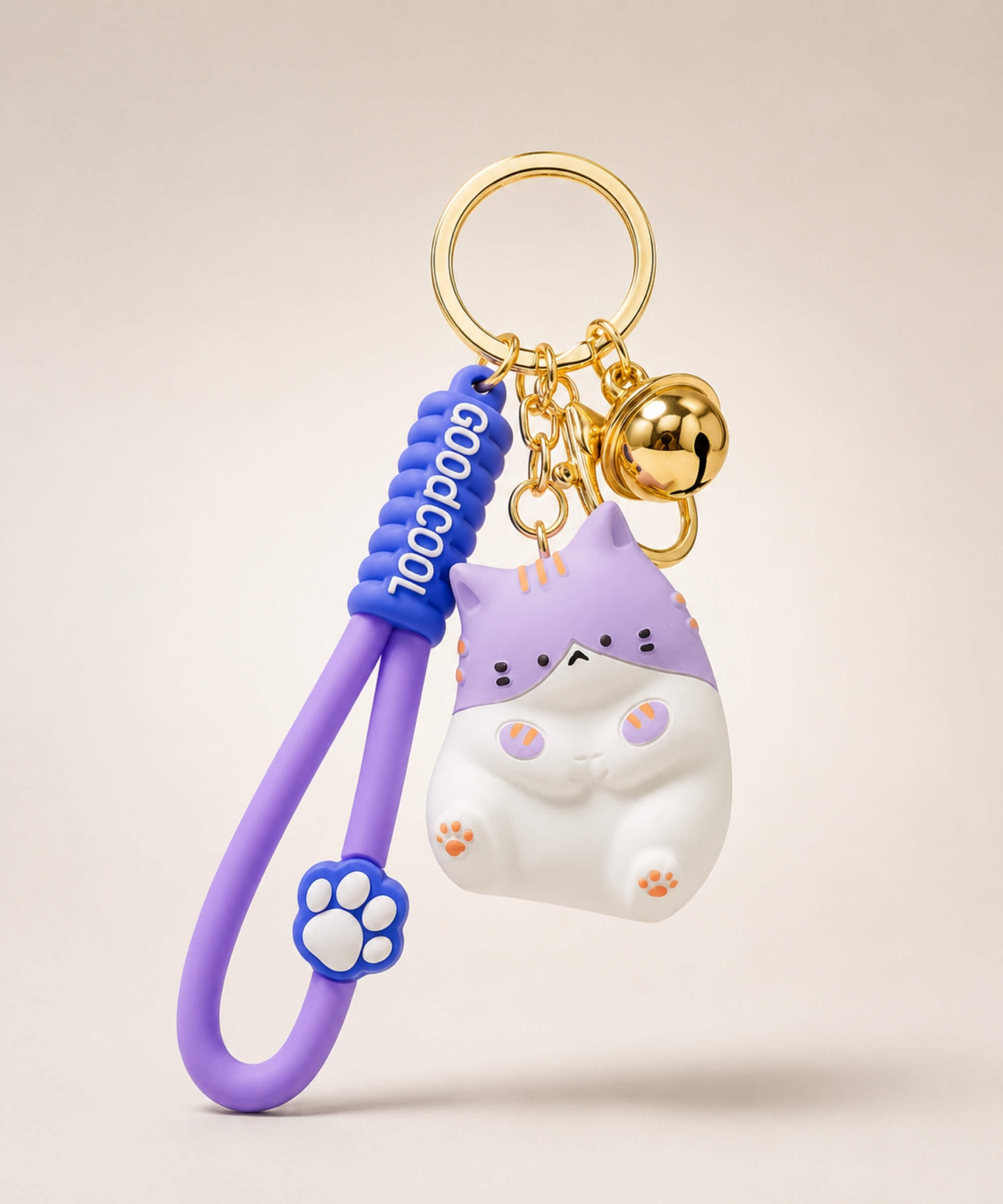 Purple chubby cat resin keychain on a neutral background.