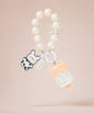 White ice cream beaded keychain with pearl-style beads and bunny charm on a neutral background