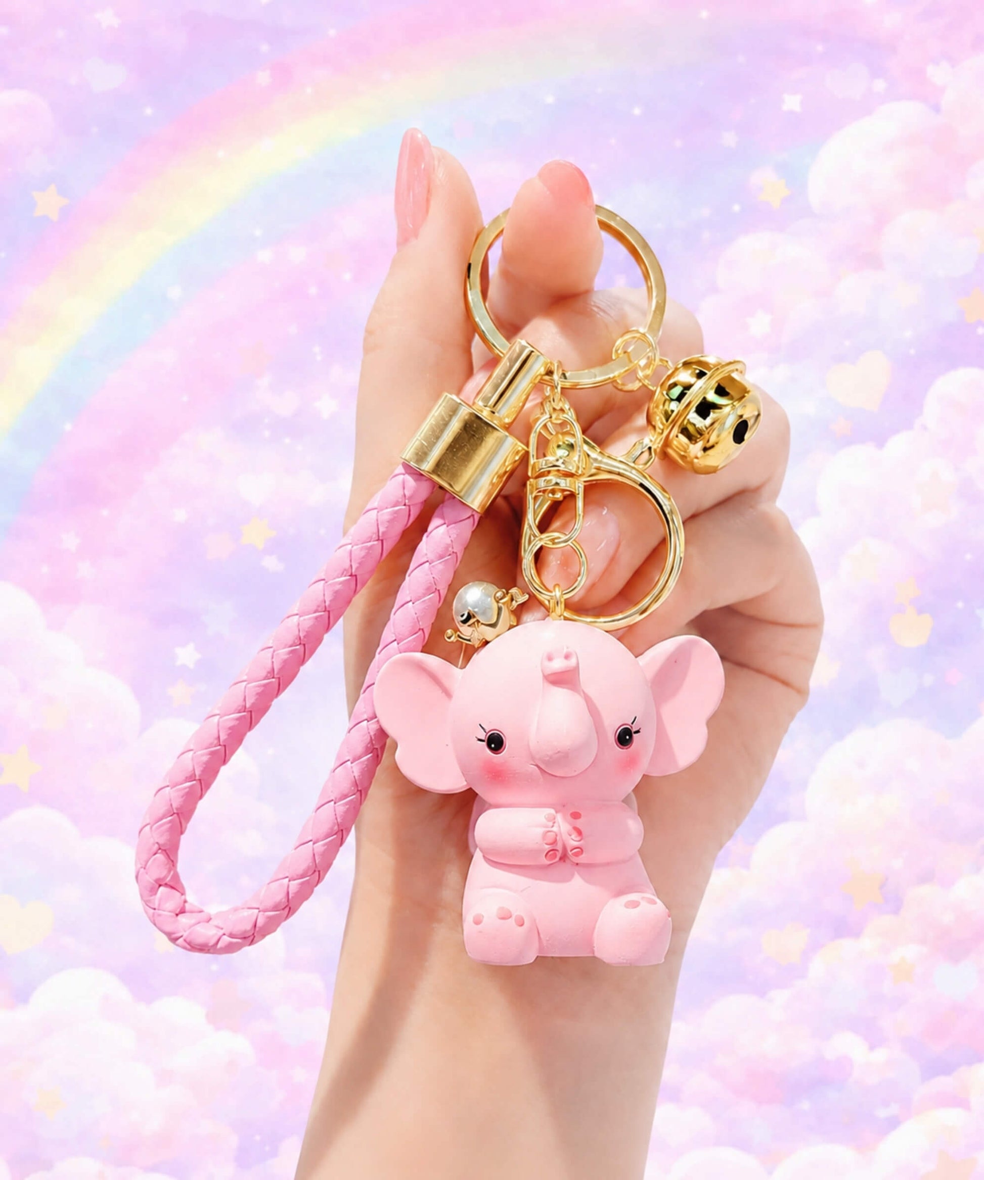 Pink elephant resin keychain held in hand