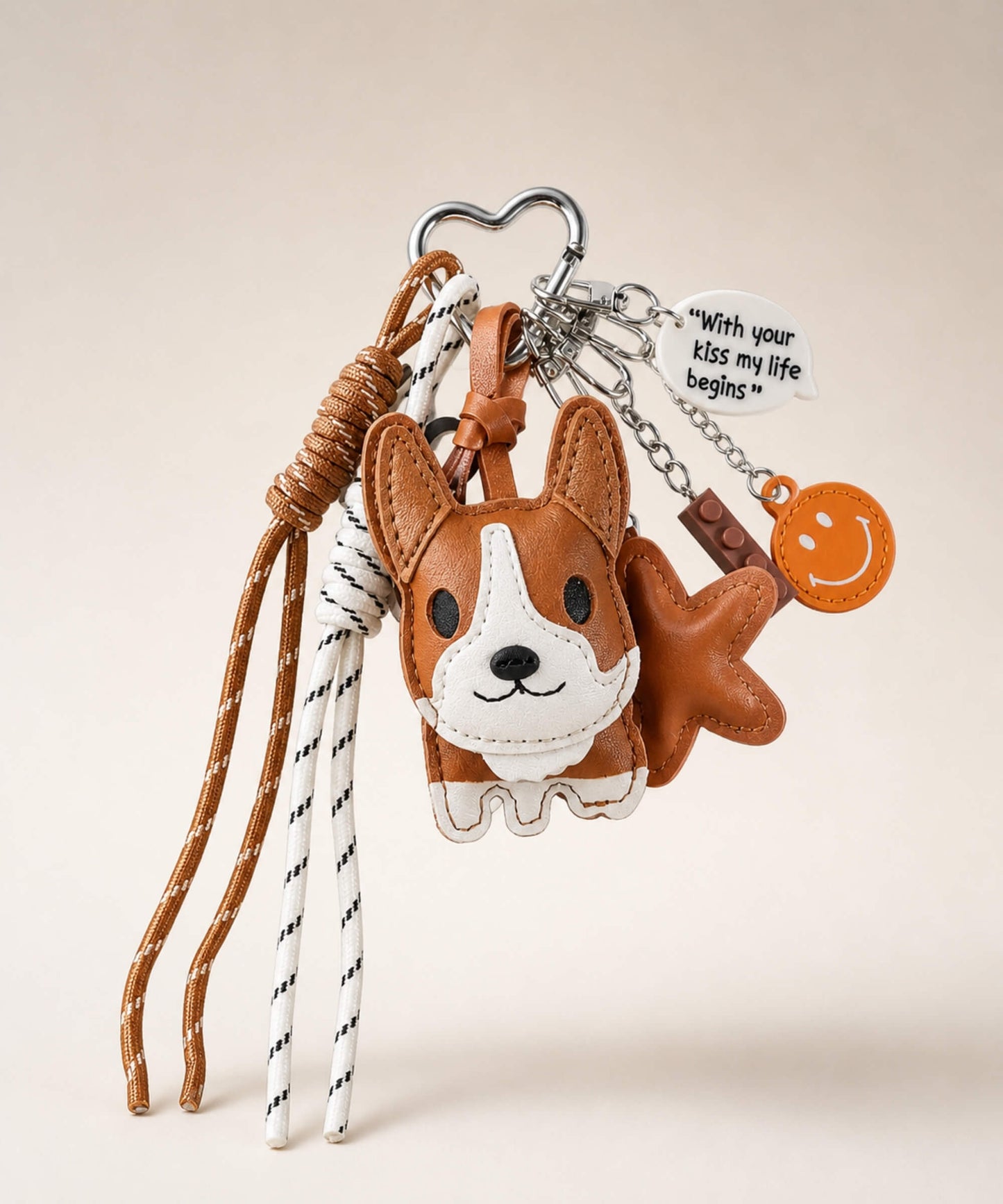 Brown Cute Corgi PU leather bag charm keychain with tassel cords and decorative charms on a neutral studio background.