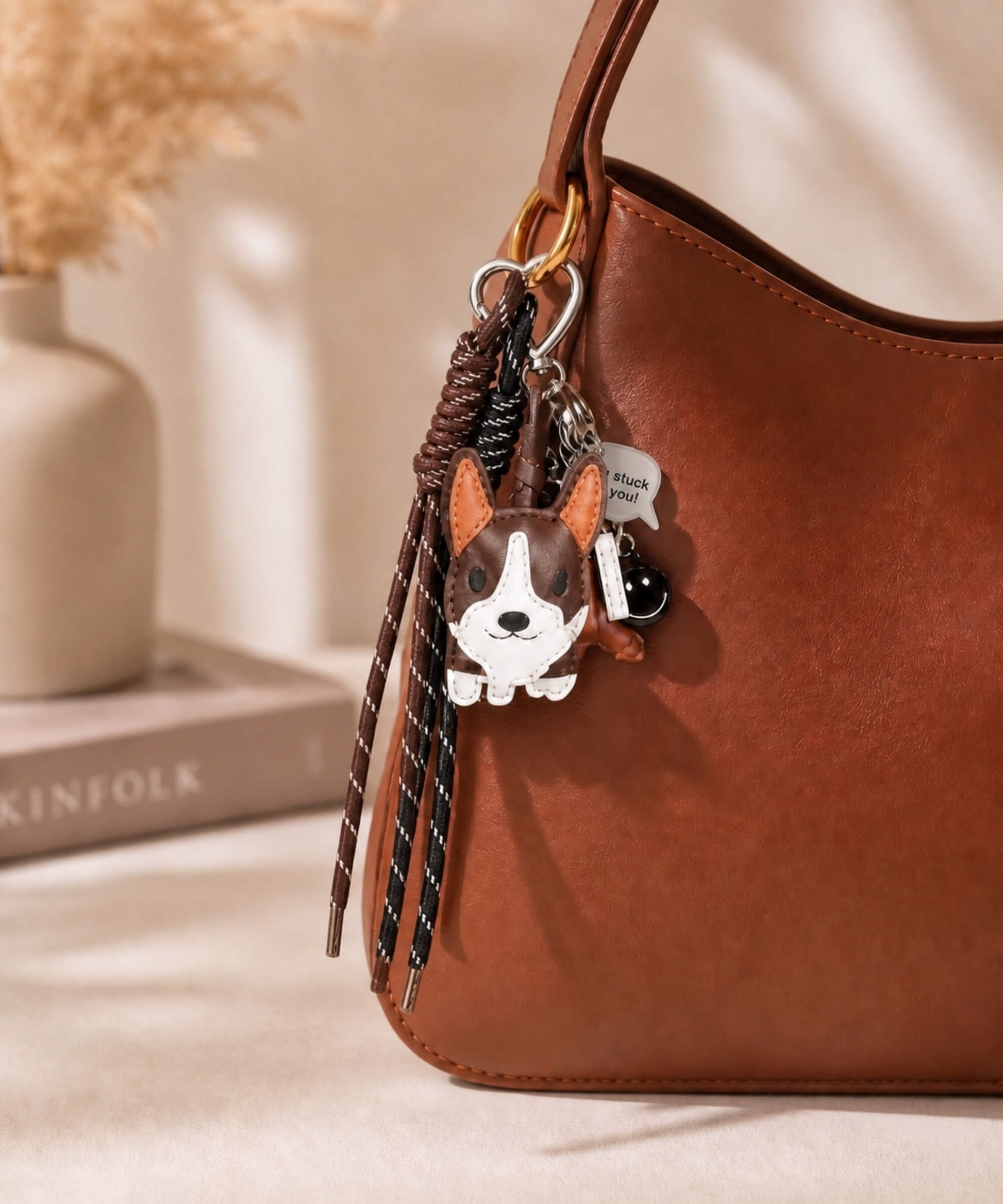 Dark brown Cute Corgi PU leather bag charm keychain attached to a brown handbag in a lifestyle setting.