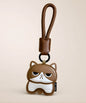 Cute Kitty PU leather keychain in brown with wrist strap on a soft neutral background.