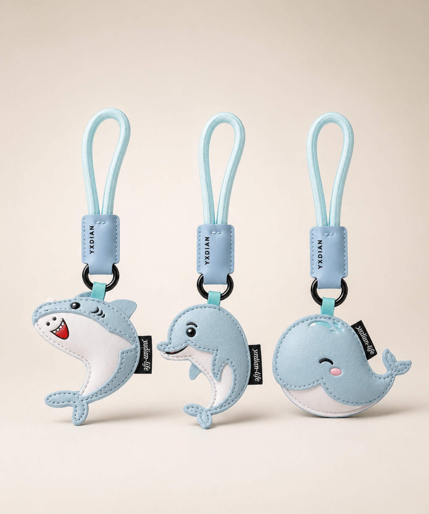 Cute ocean animal PU leather keychains featuring shark, dolphin and whale designs on a clean neutral background.