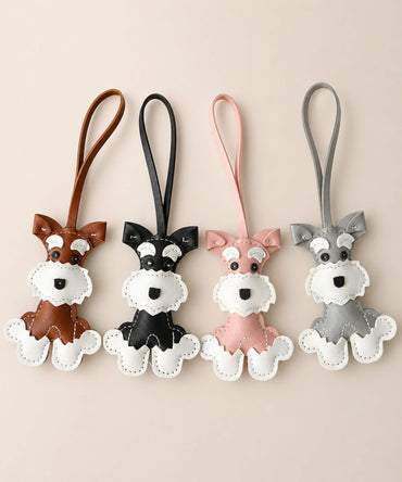Cute Schnauzer faux leather bag charm keychains in brown, black, pink and grey on a clean neutral background.