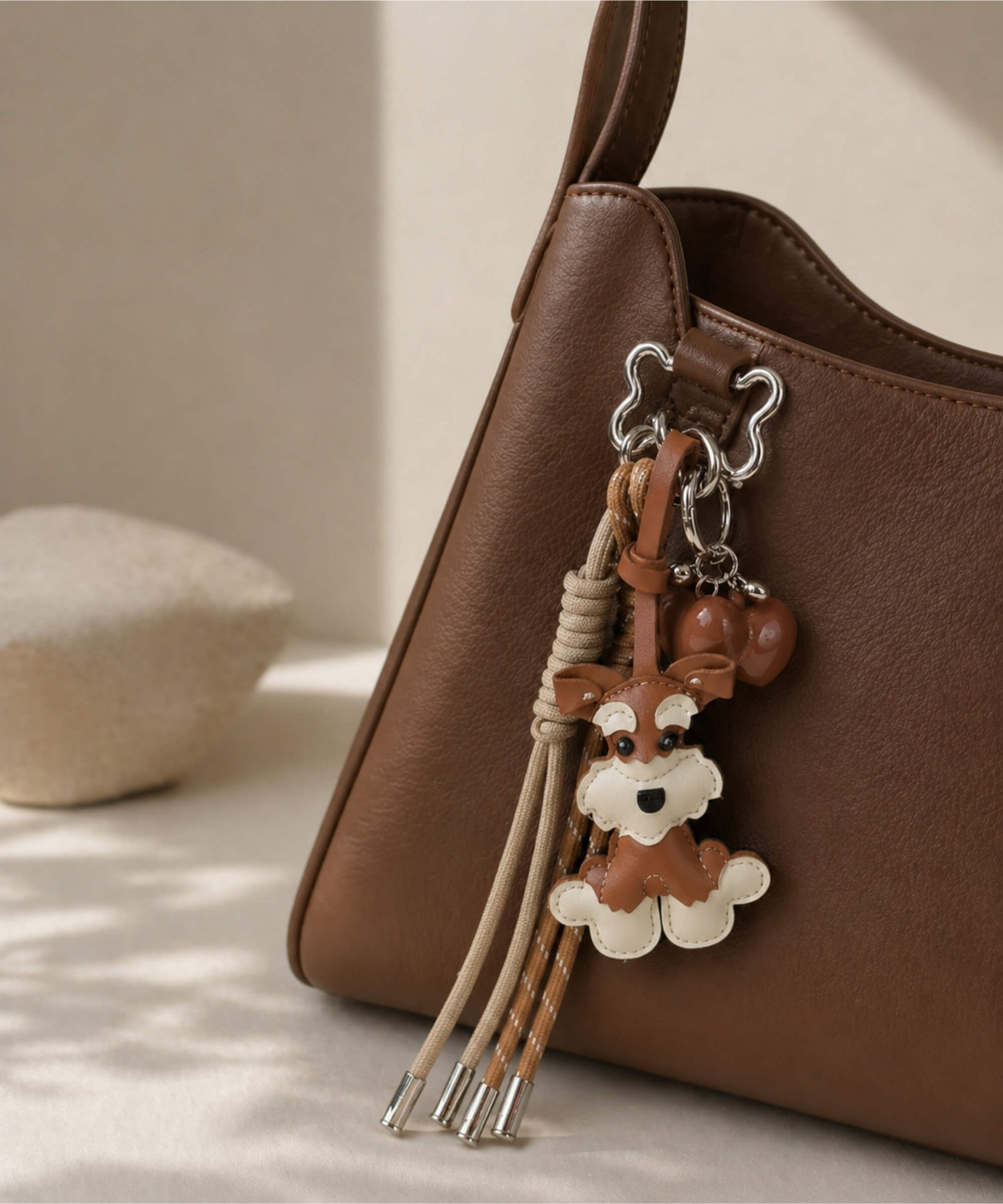 Brown Cute Schnauzer PU leather bag charm with heart pendant attached to a brown handbag in a lifestyle setting.