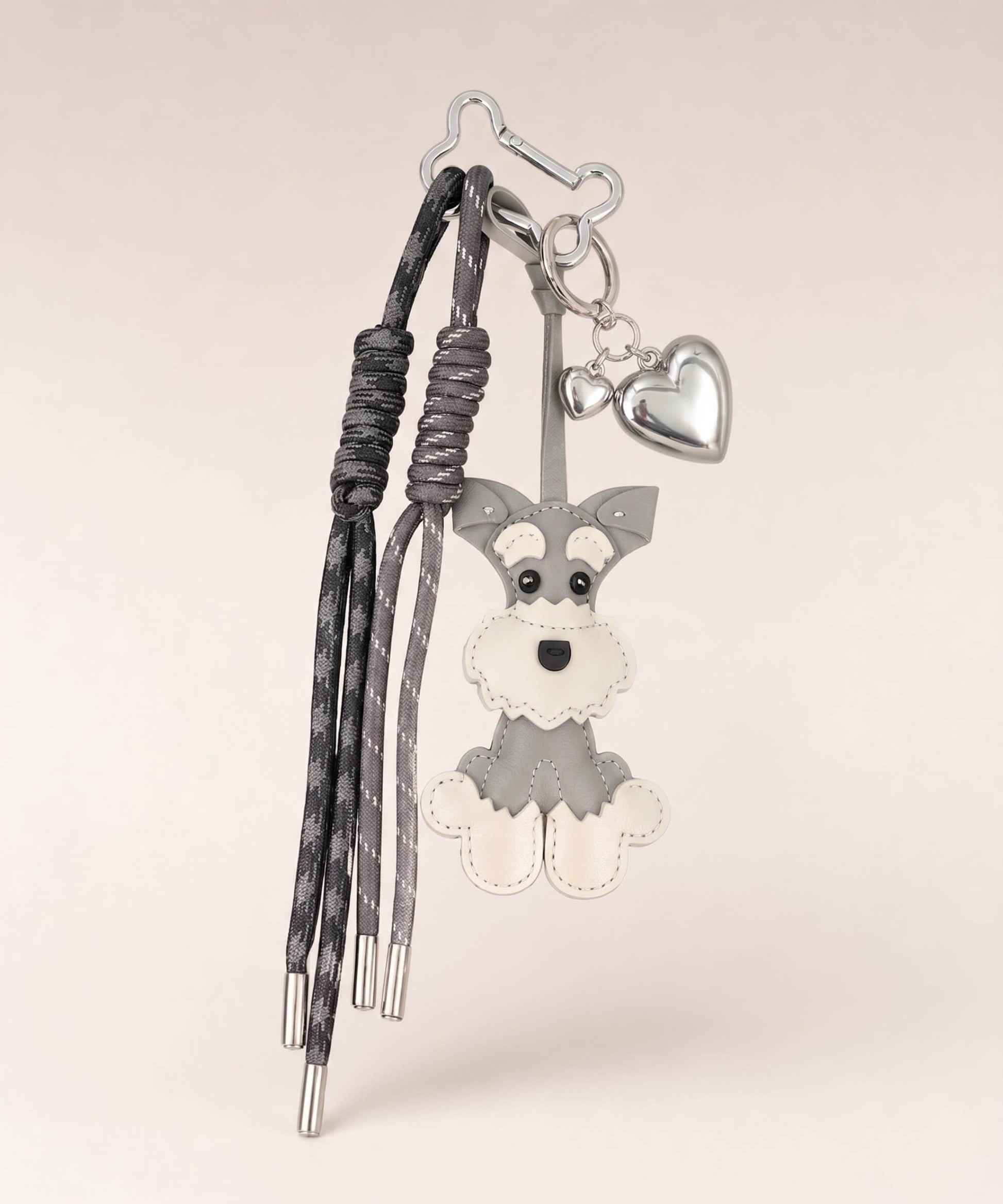 Grey Cute Schnauzer PU leather bag charm with silver heart pendant and tassel cords on a neutral studio background.