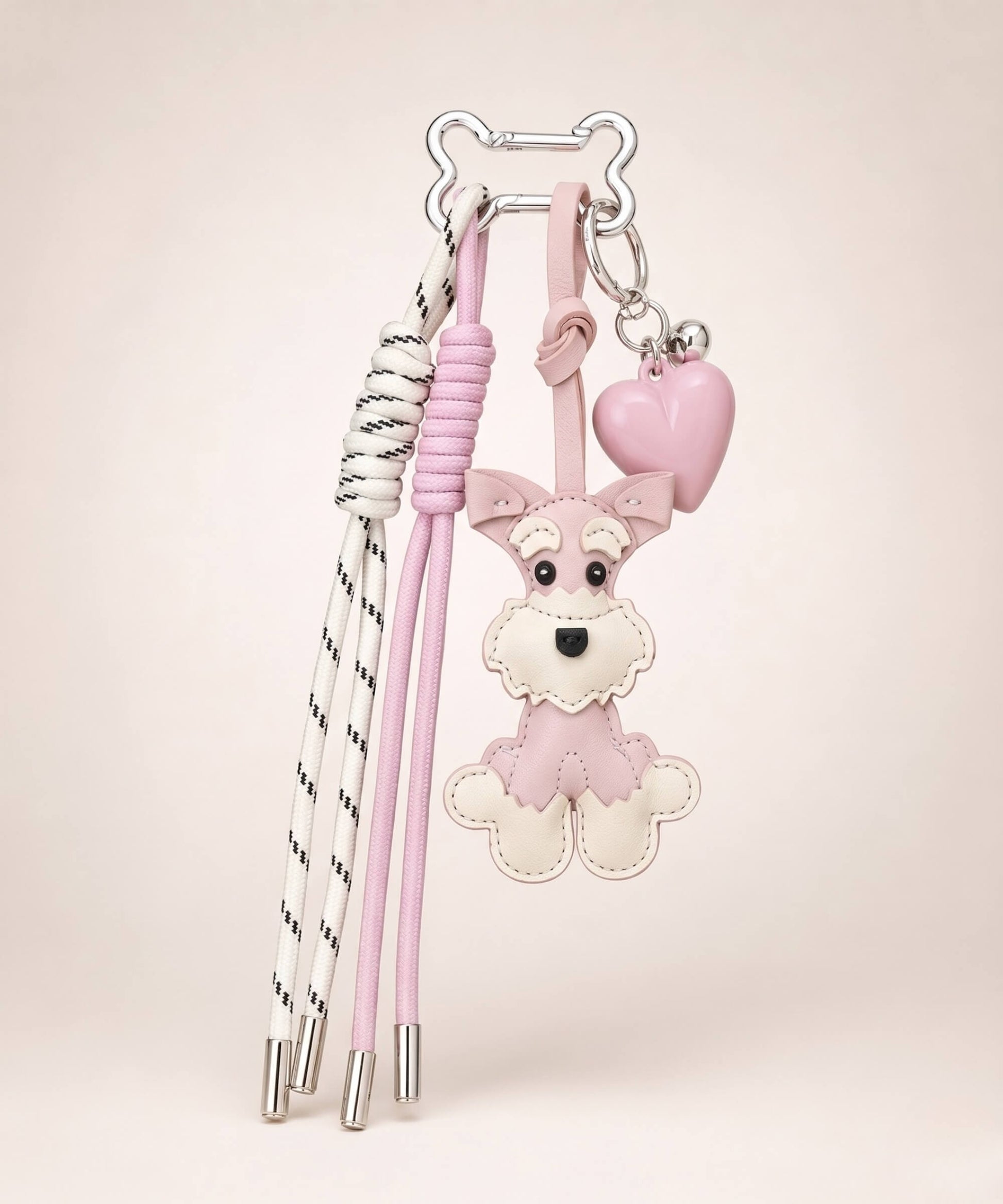 Pink Cute Schnauzer PU leather bag charm with heart pendant and tassel cords on a neutral studio background.