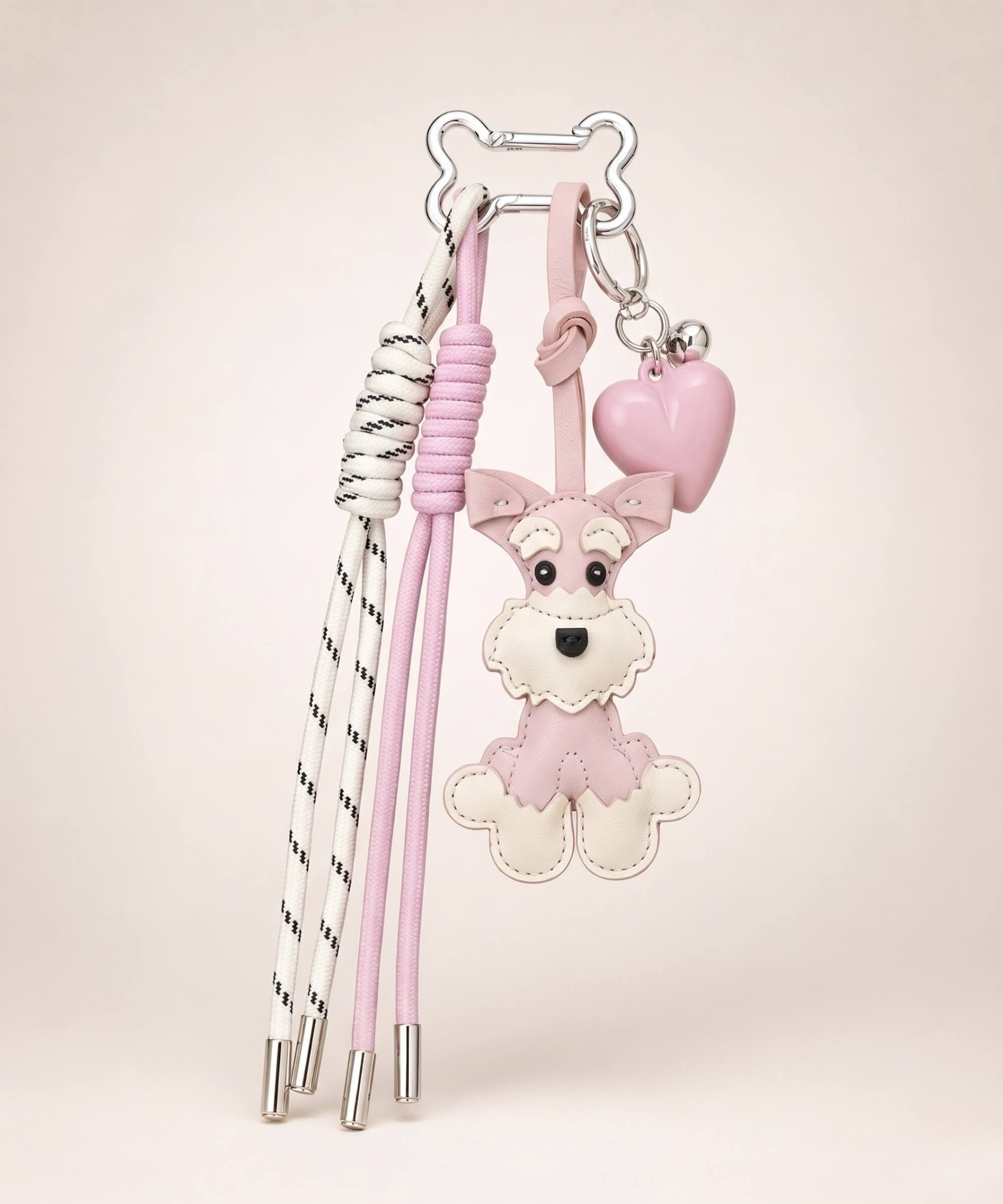 Pink Cute Schnauzer PU leather bag charm with heart pendant and tassel cords on a neutral studio background.