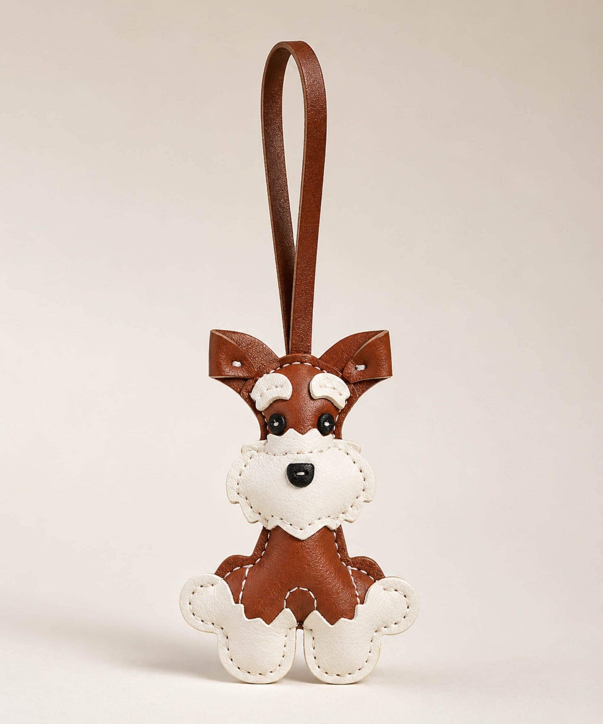 Brown Cute Schnauzer PU leather keychain with matching wrist strap on a soft neutral studio background.