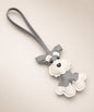 Grey Cute Schnauzer faux leather keychain with white details and wrist strap on a neutral studio background.
