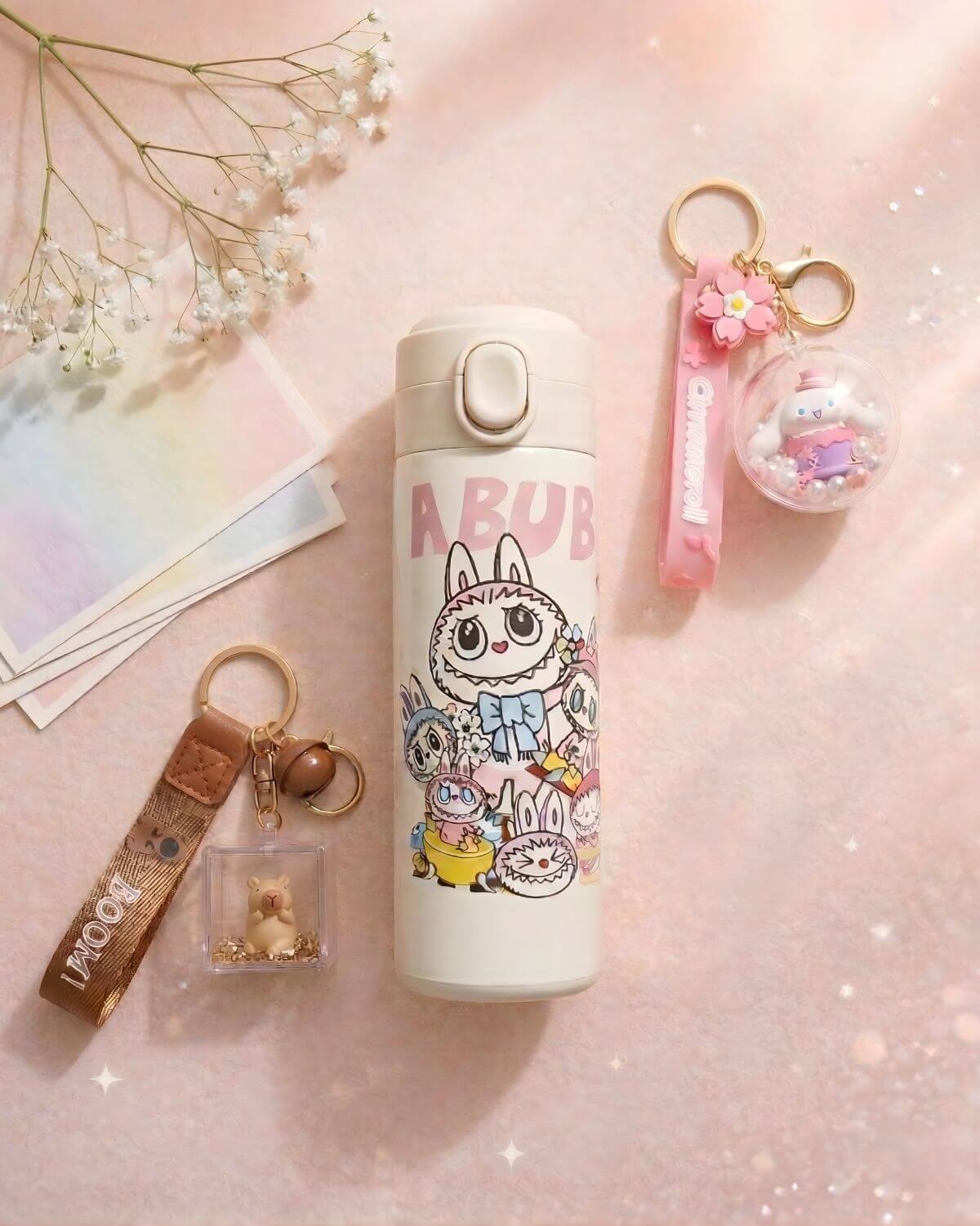 Soft pastel everyday essentials with cute Charmazing keychains and water bottle