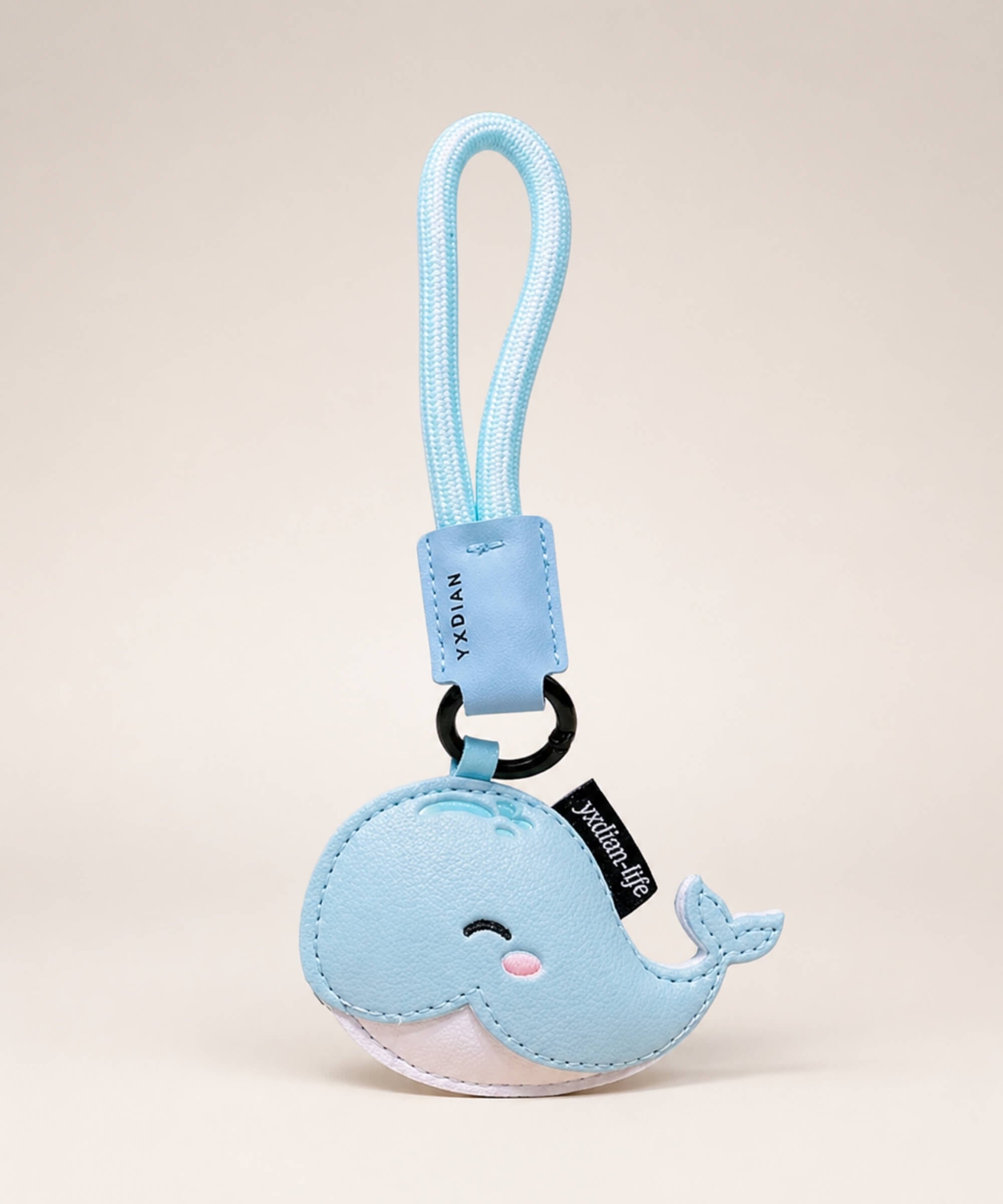 Blue cute whale PU leather keychain with wrist strap on a clean neutral studio background.