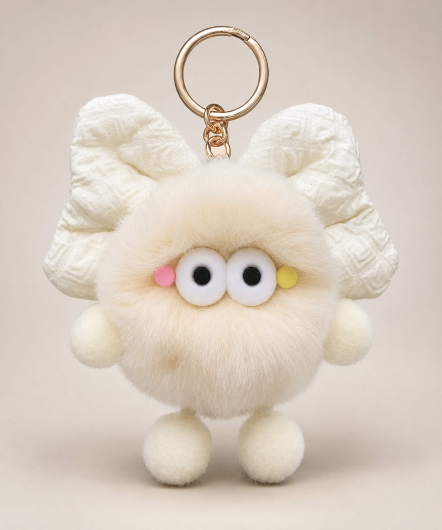 Cream fluffy bow plush keychain with soft furry body and cute wide-eye details