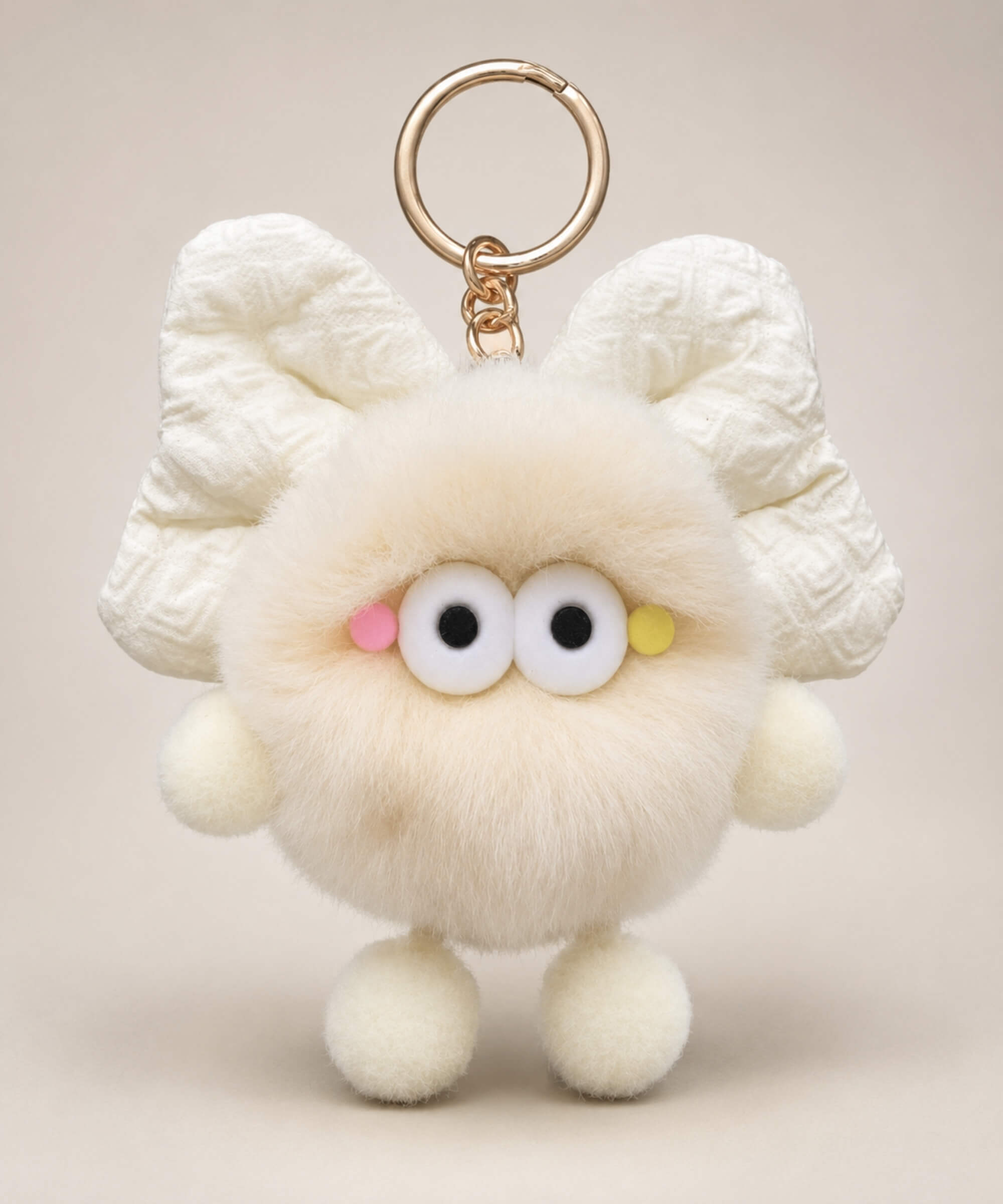 Cream fluffy bow plush keychain with soft furry body and cute wide-eye details
