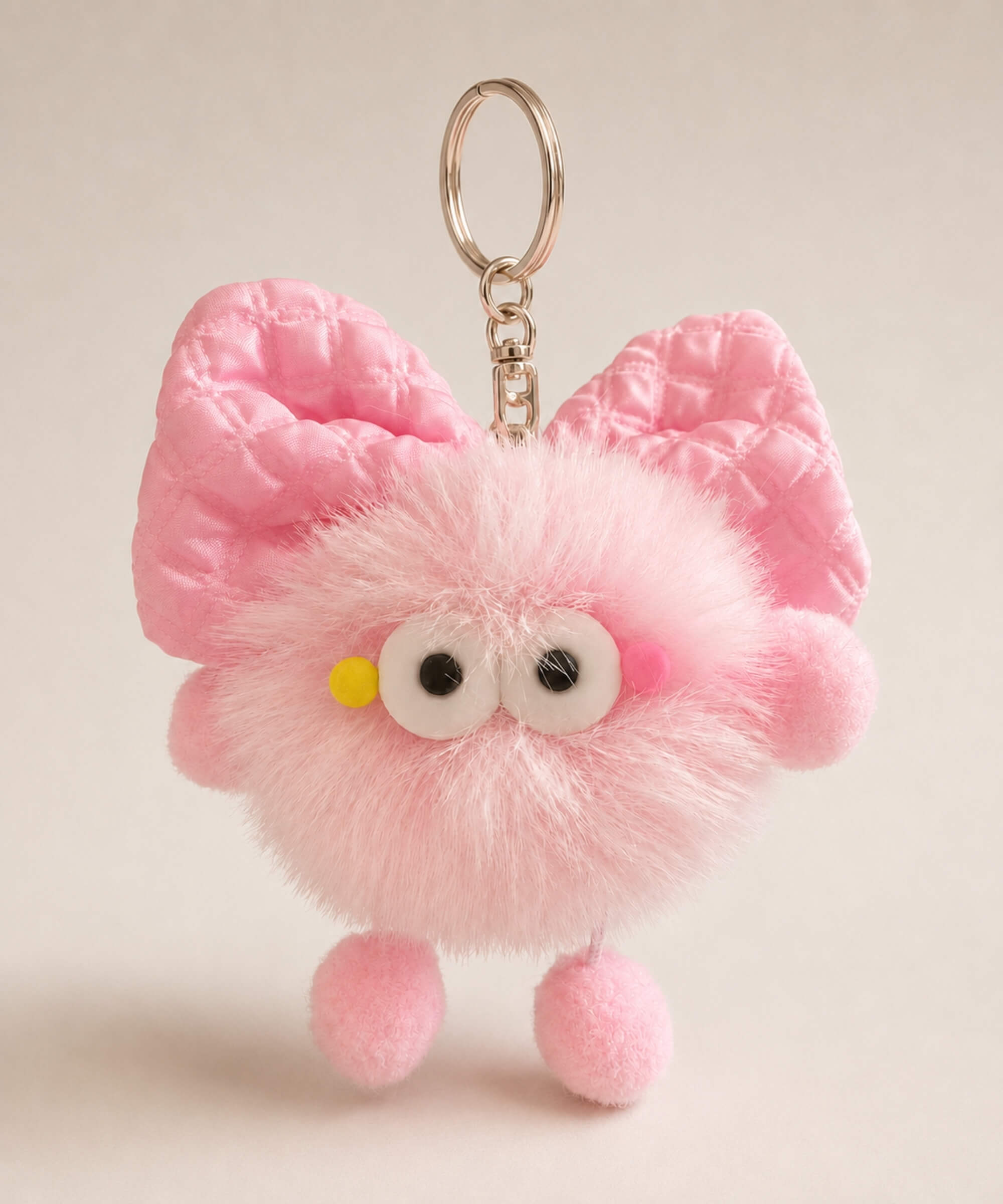 Light pink fluffy bow plush keychain with pastel bow-style ears and cute bag charm details